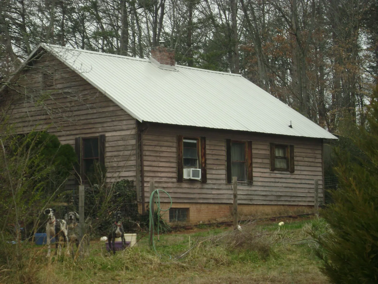 White metal roof on an old wood sided farmhouse, from a Metal Roof Installation job in North Greece